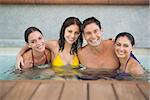 Portrait of cheerful young people in the swimming pool