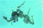 Group of young friends underwater in swimming pool