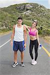 Portrait of a fit young couple standing on the open road together