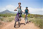 Full length portrait of an athletic couple mountain biking