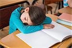 Sleeping pupil sitting at desk at the elementary school