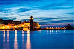 Sunset view towards Collioure's bay and a lighthouse converted to Notre-Dame-des-Anges church, Collioure, Languedoc-Roussillon, France