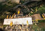 Laos, Pak Ou, Luang Prabang, Luang Prabang Province. Buddha images in the  famous Pak Ou caves which are situated on a limestone cliff overlooking the Mekong River, some 25km from Luang Prabang.
