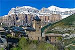 The mountain village of Torla with the snowy Pyrenees behind, Huesca, Aragon, Spain