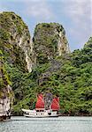 Vietnam, Quang Ninh Province, Ha Long Bay. A tourist junk anchored among spectacular limestone Karst islands in Ha Long Bay  a World Heritage Site of outstanding natural beauty.