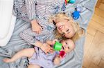 Baby with Mother laying on floor