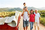 Generational family walking in vineyard