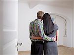 Couple in embracing in empty flat