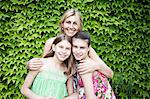 Mother and daughters in-front of bush