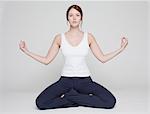girl in lotus position on white background