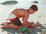 Boy making sandcastles on a beach