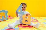 Baby boy playing with toy alphabet letters