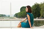 Girl by reflecting pool with washington monument in distance