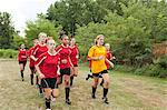 Girl soccer players running