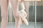 Close up on ballerina holding ballet shoes