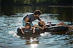 Couple and daughter having fun in lake