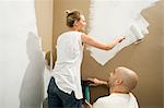 Couple painting wall