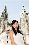Woman in front of cathedral and castle tower, Prague, Czech Republic