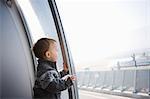 Boy looking through airport window