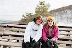 Young couple wearing winter sports clothing, portrait