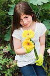 Girl holding yellow flowers