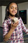 Girl holding sea shell in aquarium