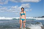 Woman wearing bikini standing in sea