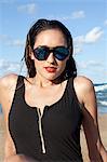 Woman on beach wearing sunglasses