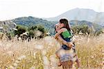 Girl carrying friend in field