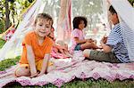 Four friends in summer netting tent