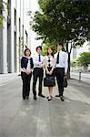 Four businesspeople on sidewalk