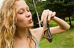 Teenage girl holding small snake