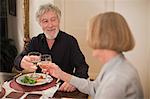 Couple toasting with wine at dinner