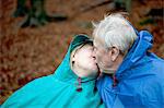 Senior couple wearing waterproofs and kissing