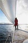 Woman standing by sail on yacht