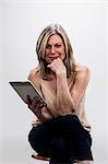 Mature woman holding digital tablet