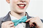 Boy adjusting bow tie