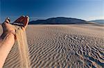 Hand holding sand in Death Valley National Park, California, USA