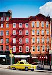 Traditional red brick buildings and old car in the trendy Chelsea district, Manhattan, New York City, NY, USA