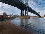 View of Manhattan and Brooklyn Bridge from under the Manhattan Bridge, East River, Main Street Park in winter, New York City, New York, USA