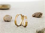 Wedding rings balanced on stone