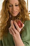 Close up of woman holding apple