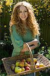 Woman carrying basket of apples