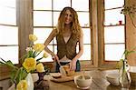 Woman slicing bread in kitchen