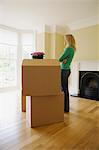 Woman with cardboard boxes in new home