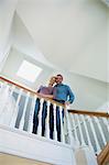 Smiling couple standing on stairs