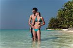 Couple hugging in water on beach