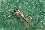 Woman floating in tropical sea