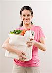 Woman carrying bag of groceries