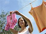 Woman hanging socks on clothesline